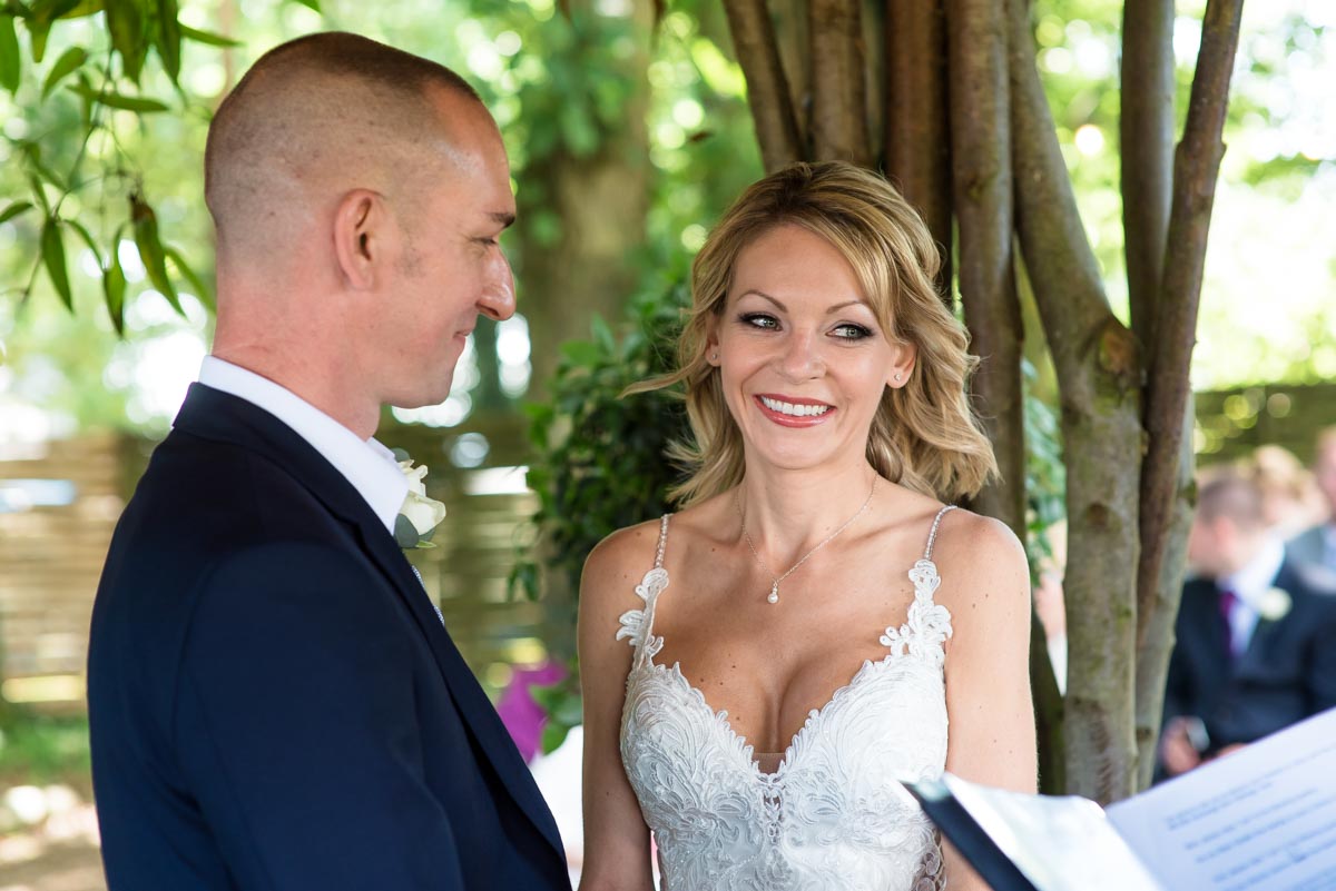 Bride and groom during outdoor ceremony at Crown Lodge wedding venue in Kent