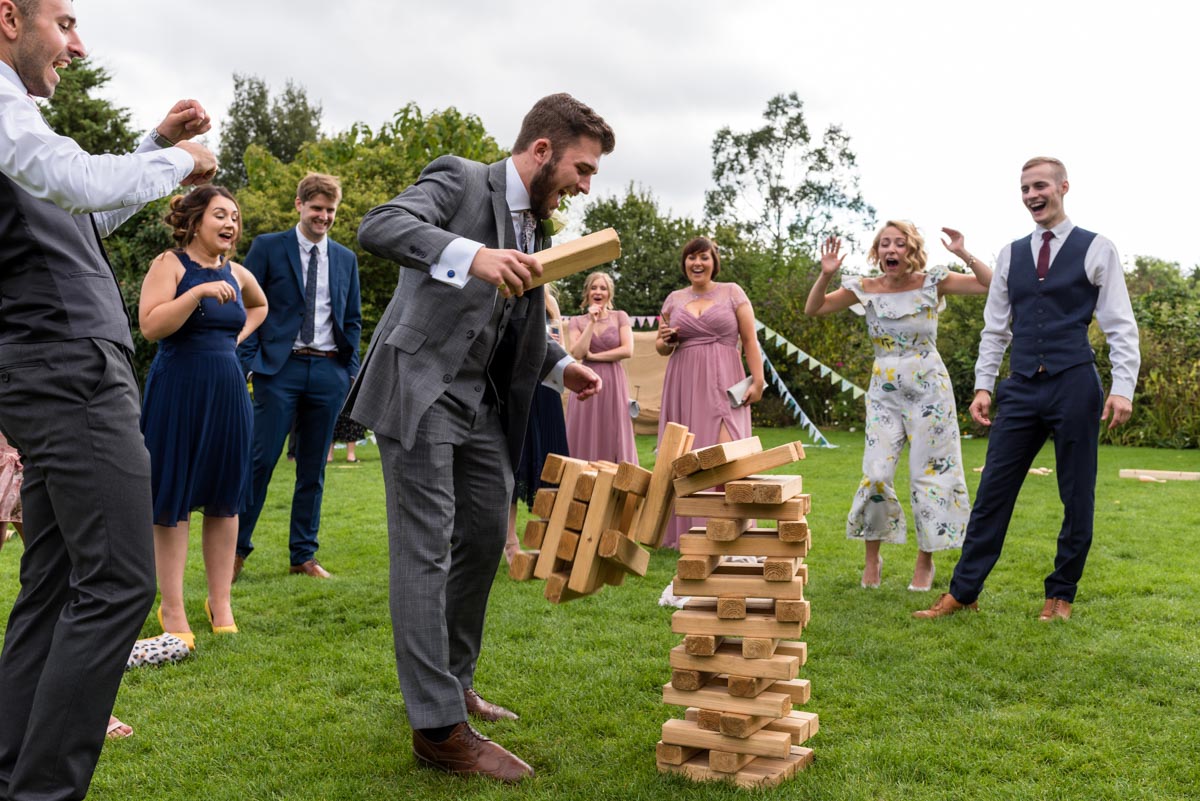 Wedding guests play giant jenga at The Gardens Yalding wedding