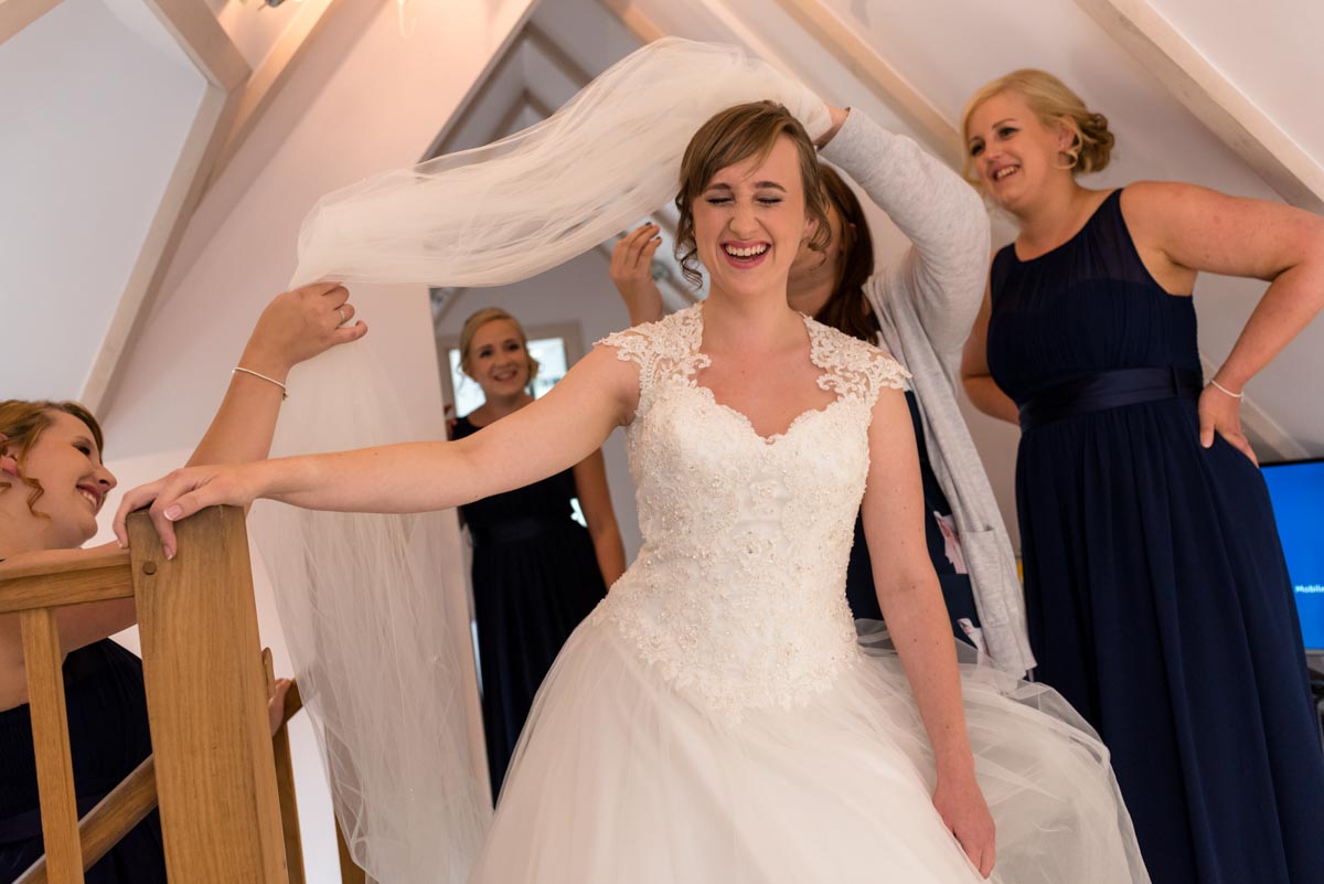 Photograph of bride getting ready before her wedding at The Secret Garden in Kent