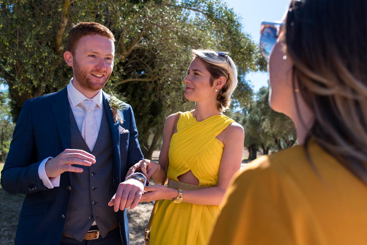 matt chats with friends before hsi wedding ceremony at castell d'emporda