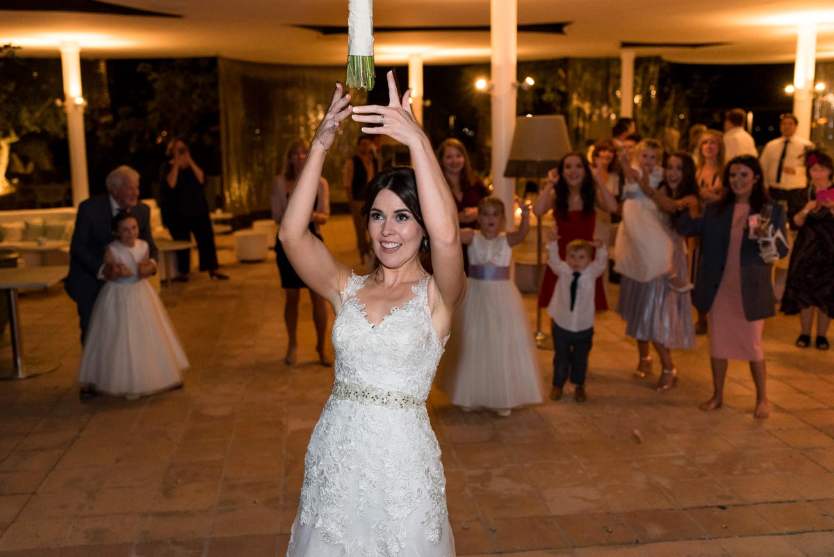 rebecca is photographed throwing her wedding bouquet