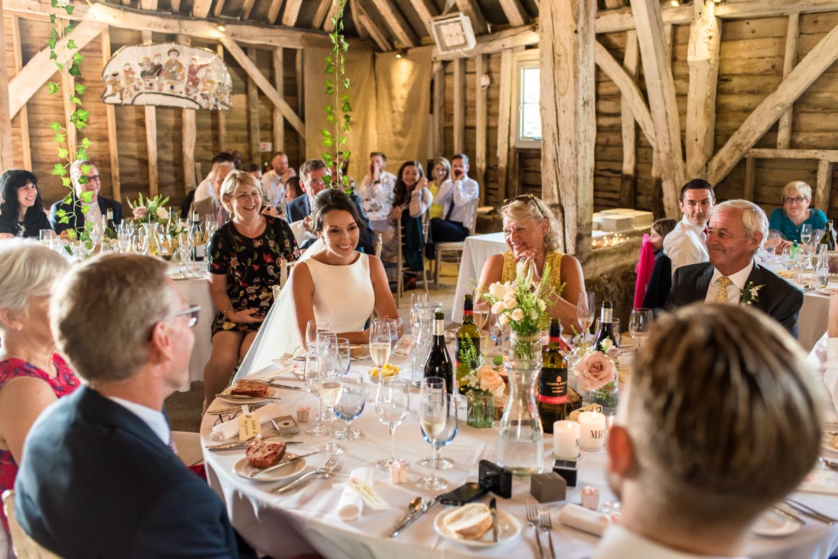 Odo's Barn wedding photography, Sarah and family and friends listen to grooms speech
