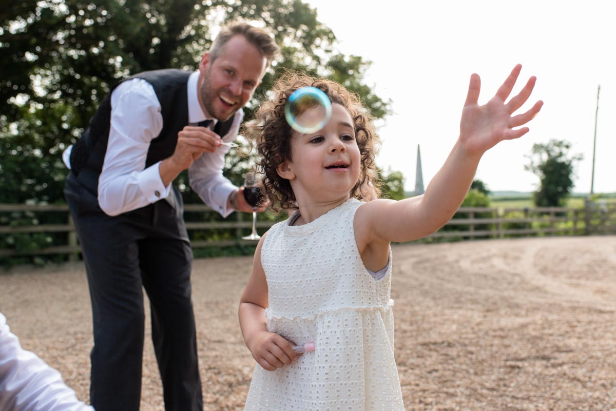 Craig has games with flowergirl at Odo's Barn wedding