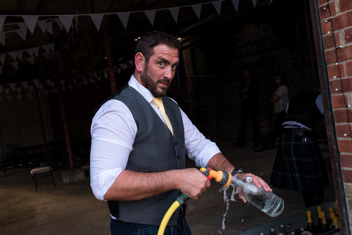 Photograph of wedding guest topping up water bottle