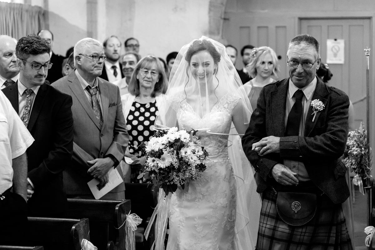 Photograph of Hannah walking down the church aisle in Preston, Kent