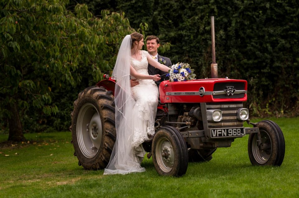 Farmyard wedding in Kent - Hannah and Matthew on the tractor