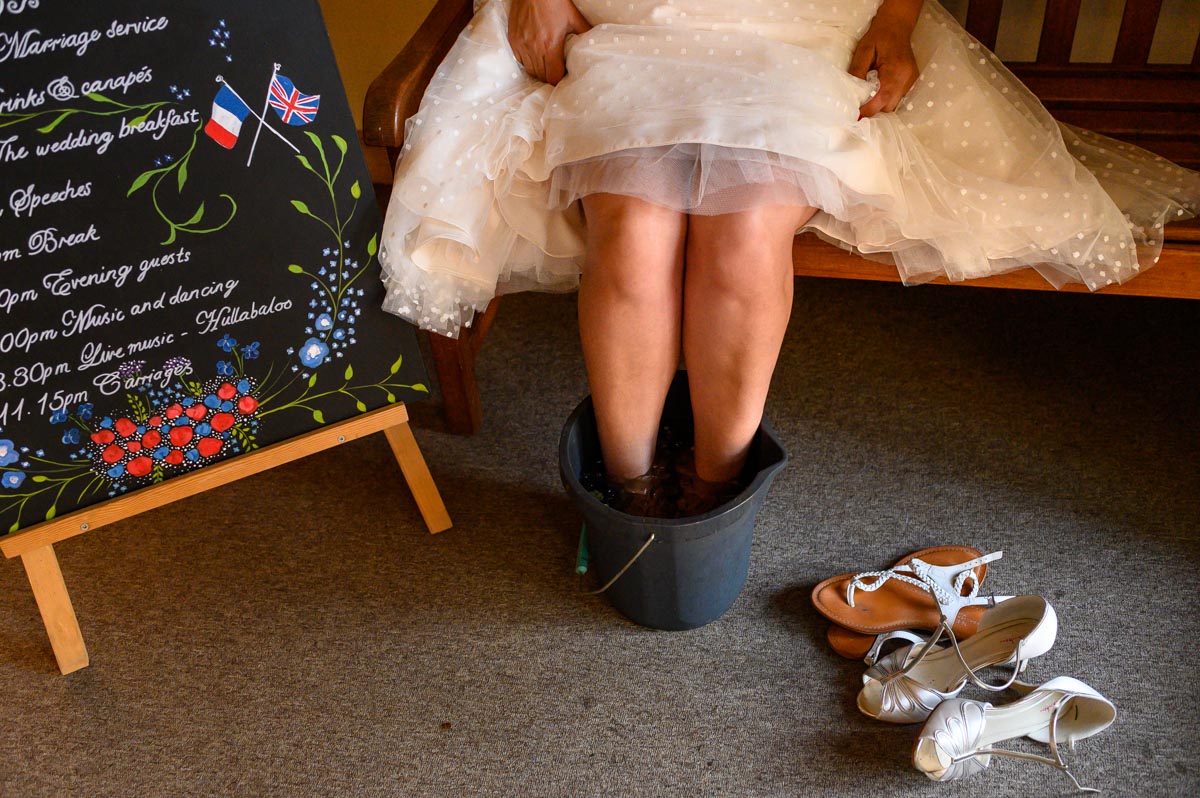 Nathalie soaks her tired feeet after her Kent Church wedding in Egerton