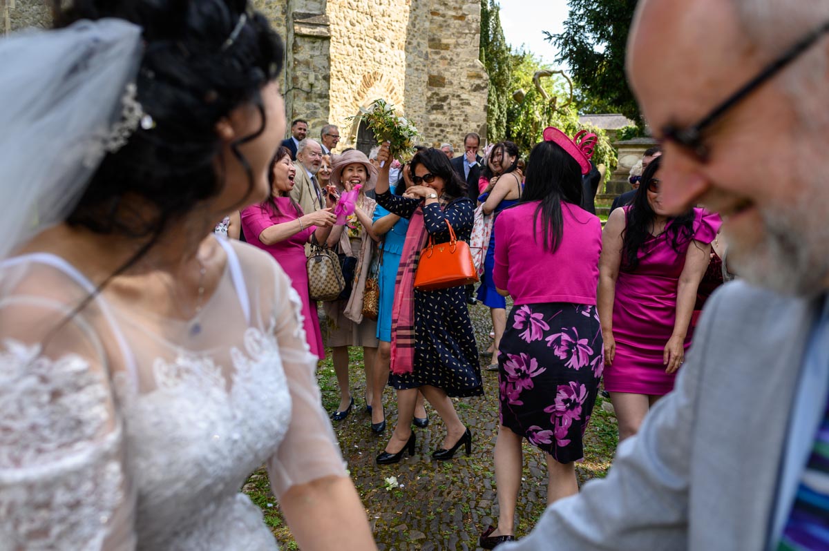 Throwing the bouquet at John & Bins church wedding