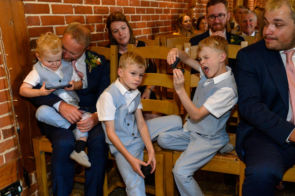 Page boys play at Ferry House Inn summer wedding