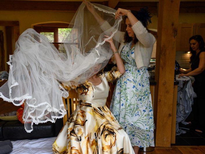 Tricia getting veil on before Solton Manor wedding ceremony