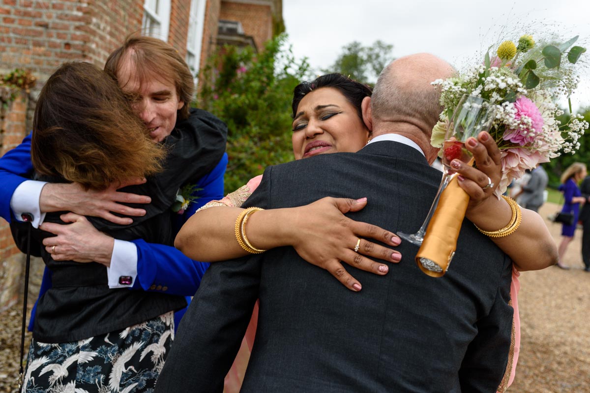 Chiston Park wedding photography, Vinita and Doug hug their guests