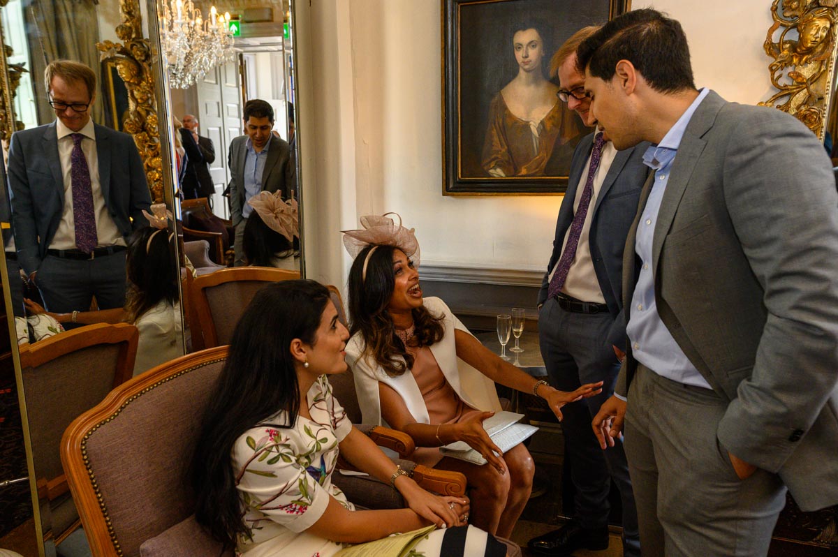 Wedding guests chat at Chilston Park wedding in Kent