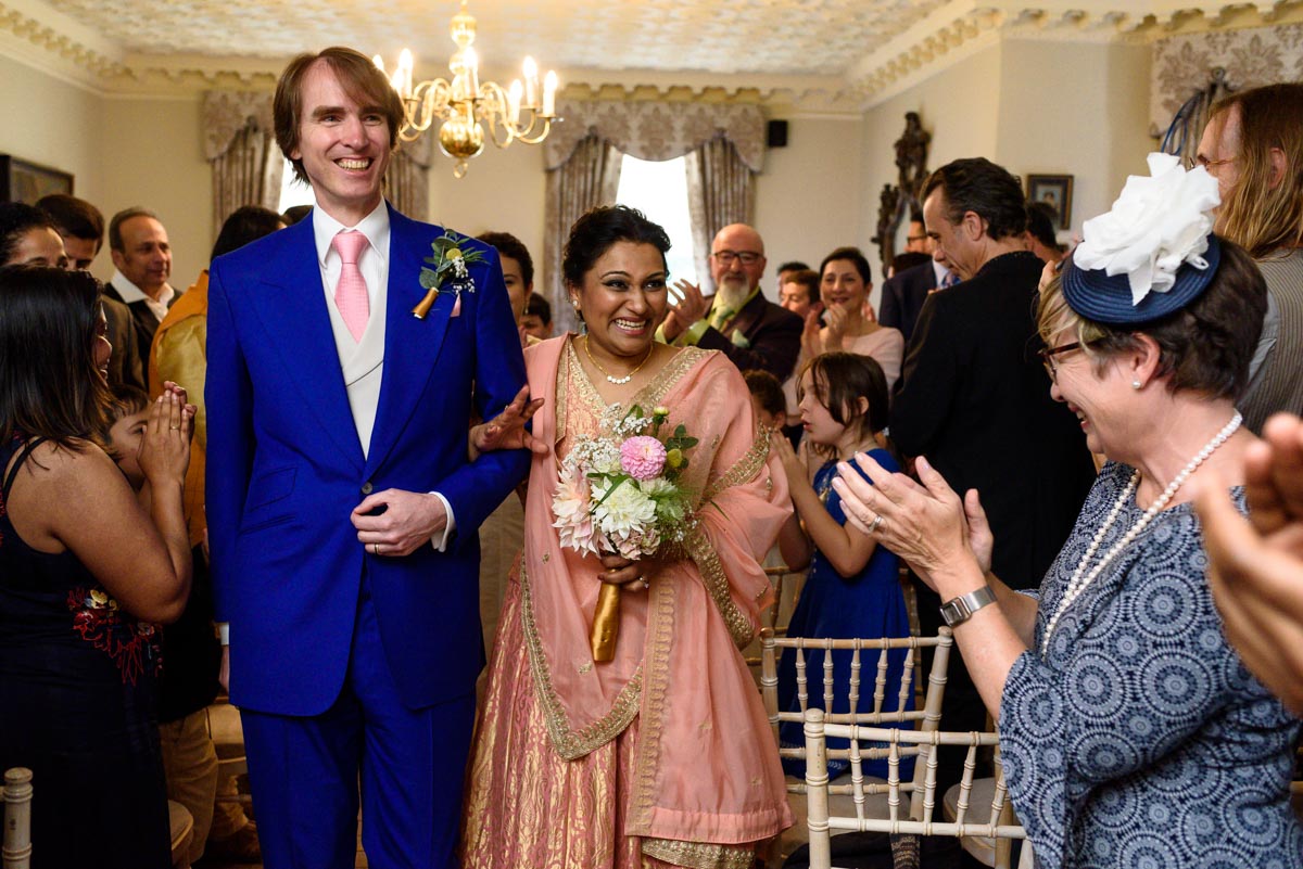 Newly weds Doug and Vinita walking down the aisle after their Chilston park wedding ceremony