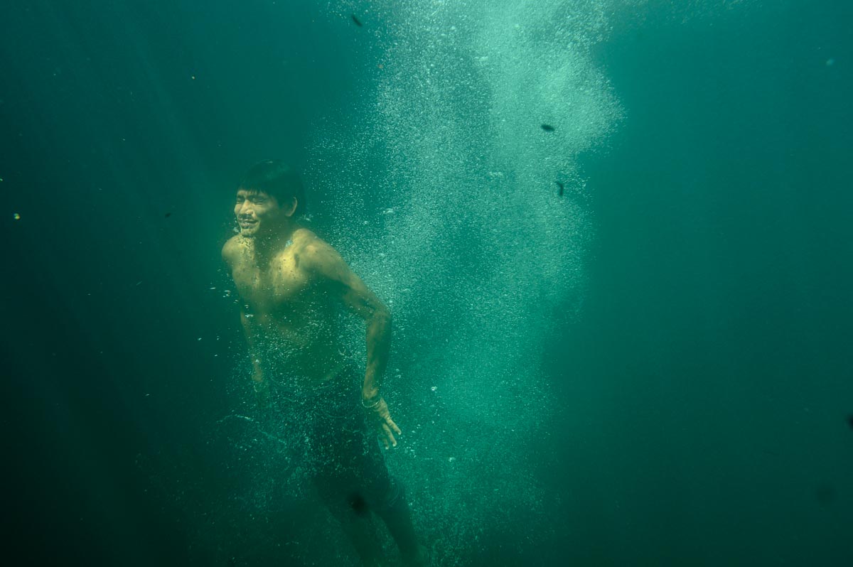 swimmer coming up for air in cenote