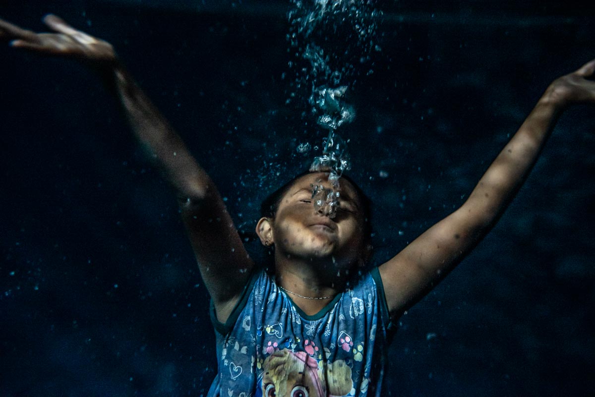 girl swimming in cenote