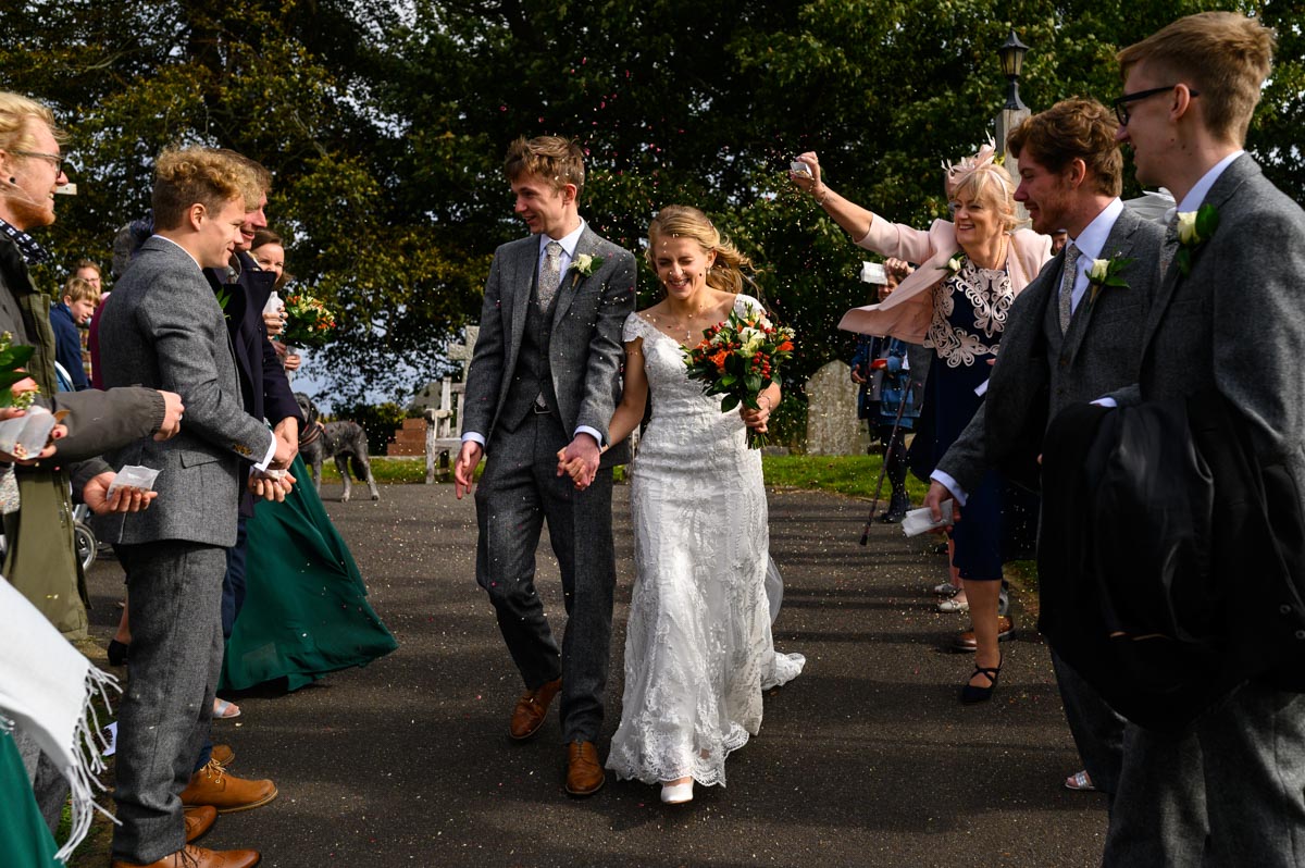 Rebecca and Jonathan have confetti thrown on them during their pandemic wedding