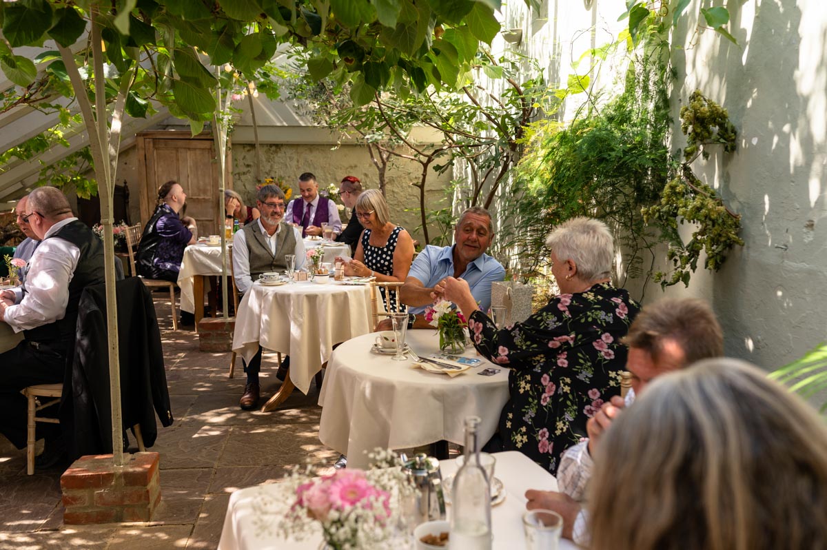Reception in the glasshouse wedding venue at the secret garden. people in their bubbles
