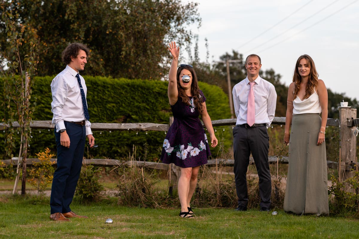 wedding photography best of 2021 photograph of wedding guests playing boule at reception in kent