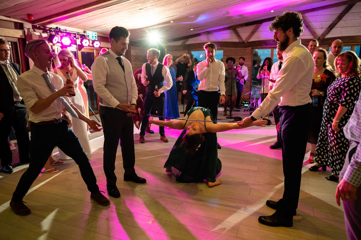 wedding photography best of 2021 photograph of bridesmaid doing limbo dancing at kent wedding reception