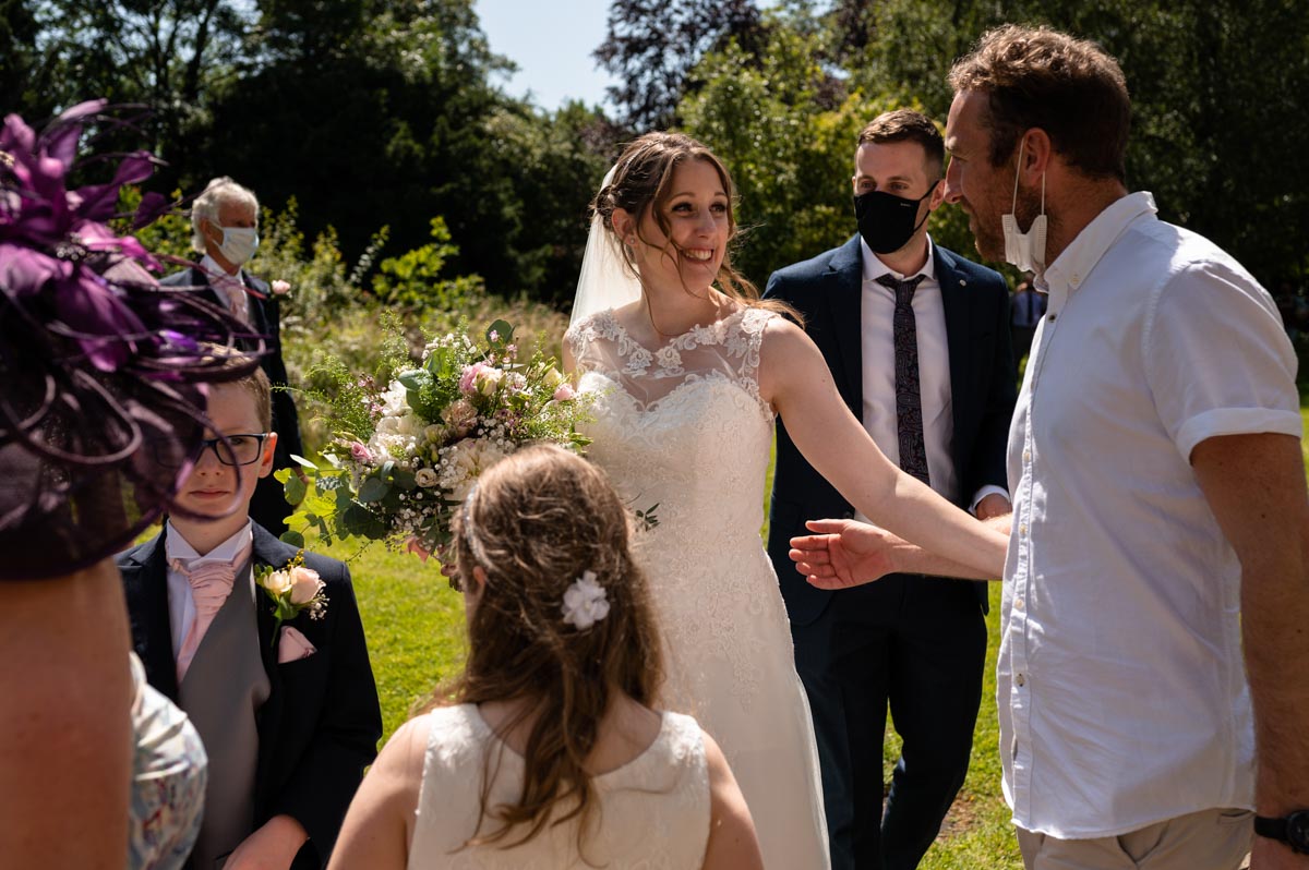 wedding photography best of 2021 wedding photography of bride and brother after wedding ceremony at kent church