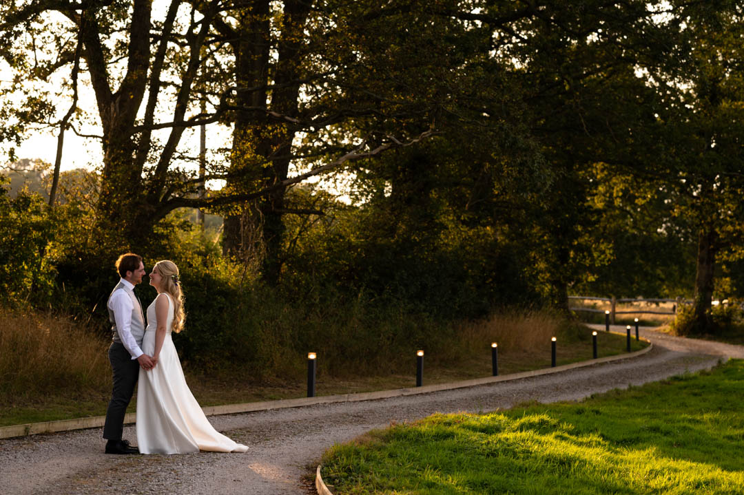 Portrait photograph of bride and groom at The Cherry Barn wedding venue in Peasmarsh