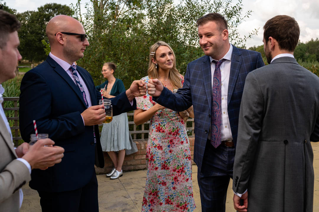 Wedding guests greet each other at The Cherry Barn wedding venue