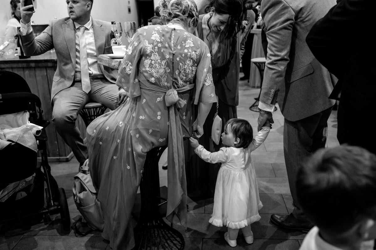Black and white photograph of guests at Sophia and Wills wedding reception at The Oak Barn, Frame Farm in Kent