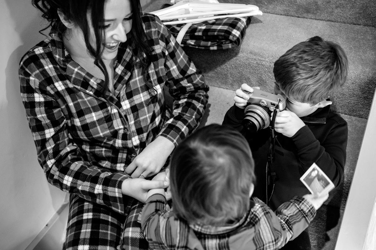 Bride, daughter and nephew photographed together at The Oak barn, Frame Farm wedding venue