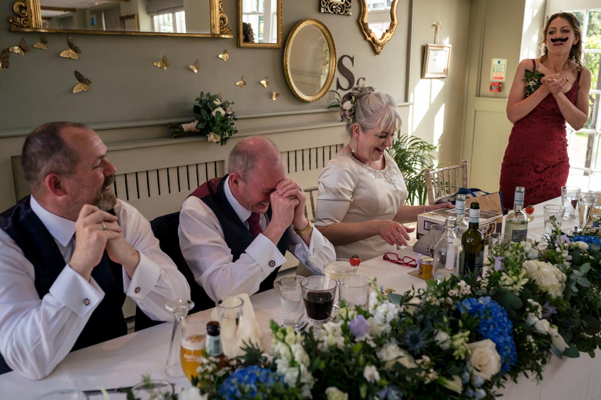 wedding photography in the coach house during speeches at the secret garden in kent