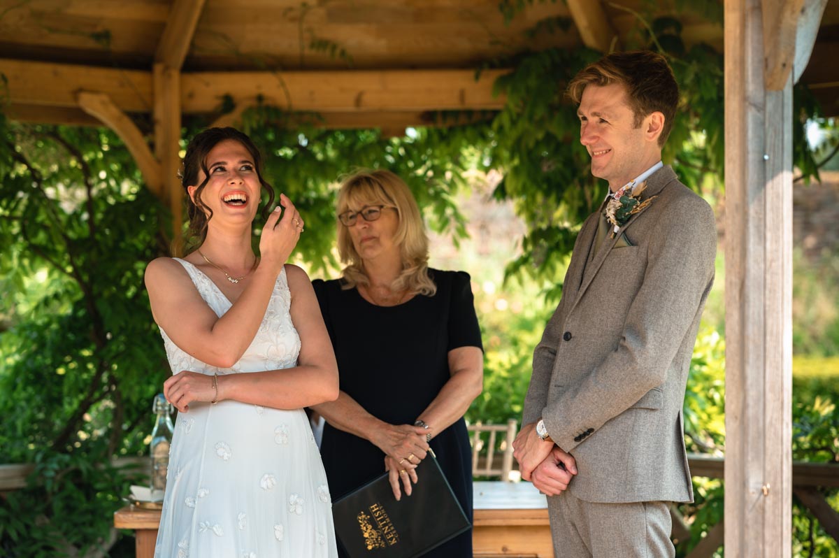 photograph of becca and freds wedding ceremony in the garden gazebo at the secret garden in kent