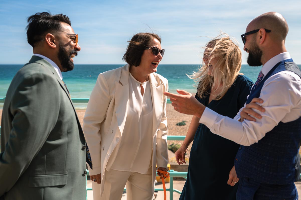 Bride and her guests laughing at east sussex wedding