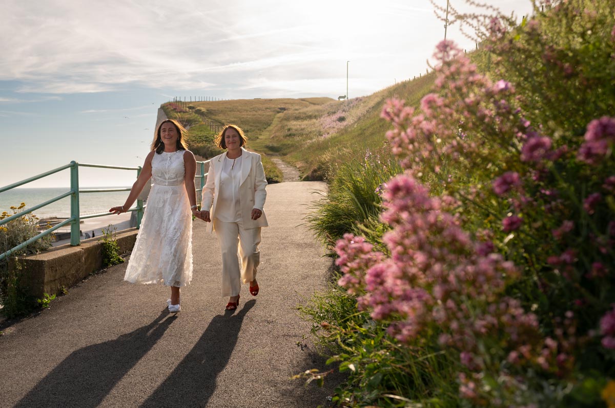 east Sussex wedding photography. Brides walking hand in hand