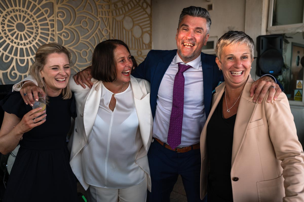 Natural wedding photography. Guests enjoying reception