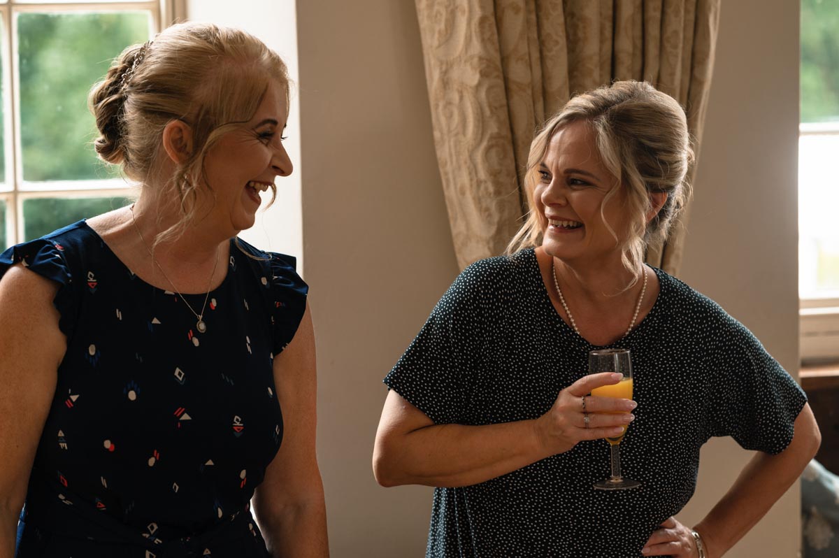 westenhanger castle wedding. Bride and maid of honour laughing