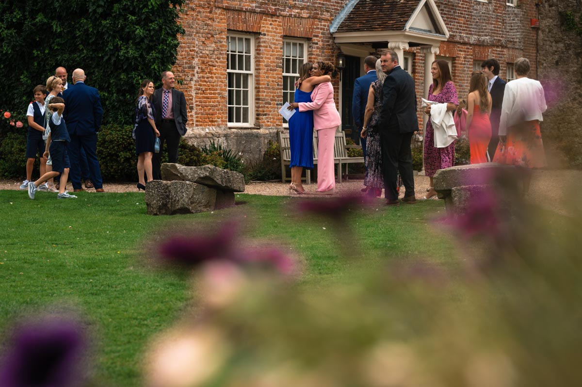 lara and phils wedding guests photographed outside at westenhanger castle wedding venue