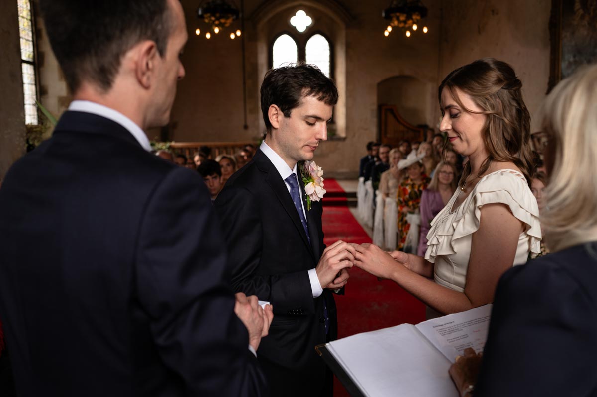 Poppy and Pablo exchange wedding rings at their Bilsington Priory wedding near Ashford in Kent