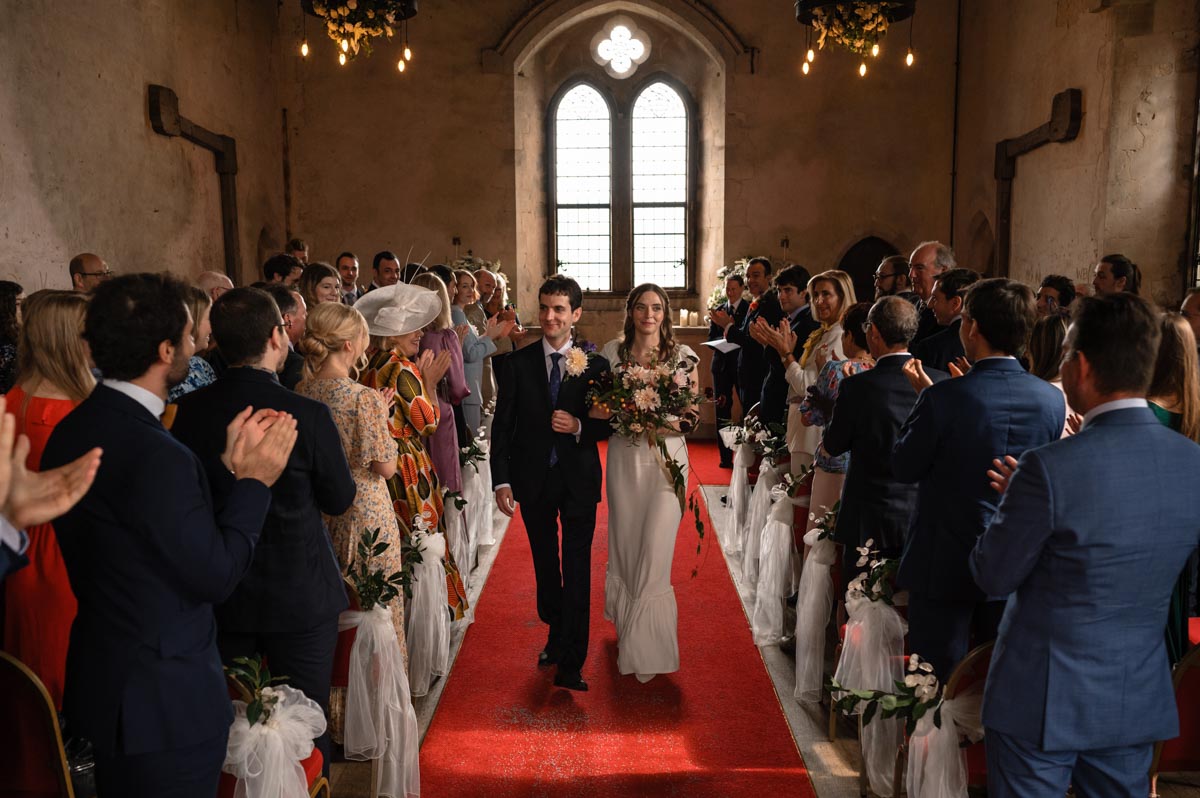 Pablo and Poppy exit after their ceremony at Bilsington Priory in Kent