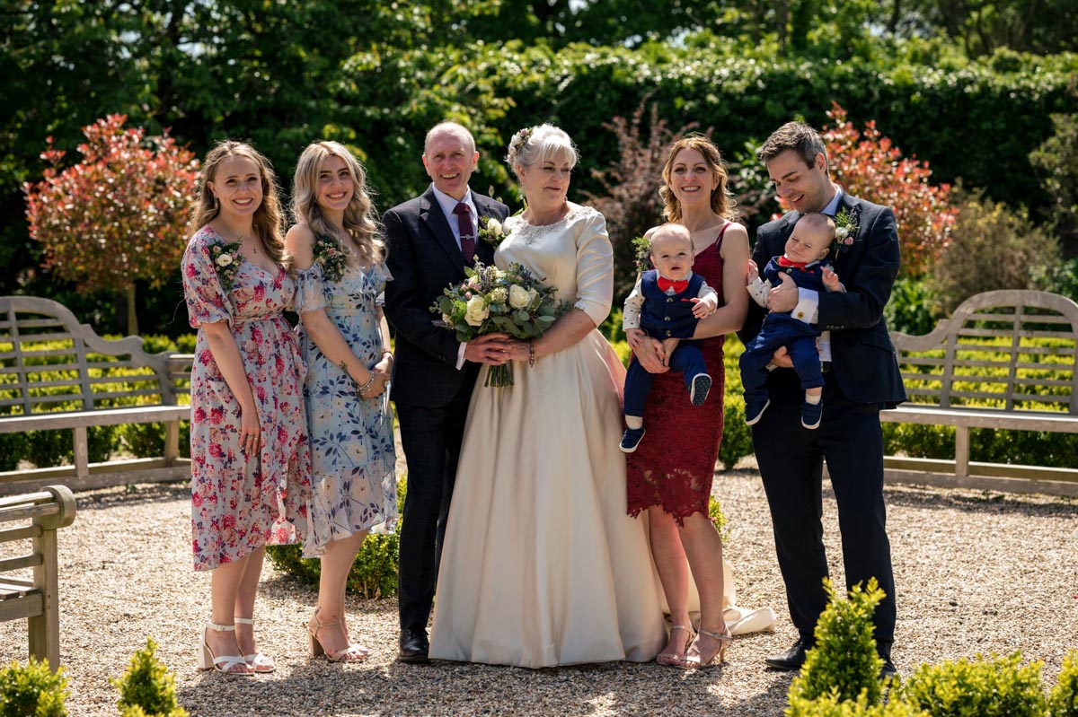How I approach photographing your wedding group photos. Example of group photo at the secret garden near Ashford in Kent