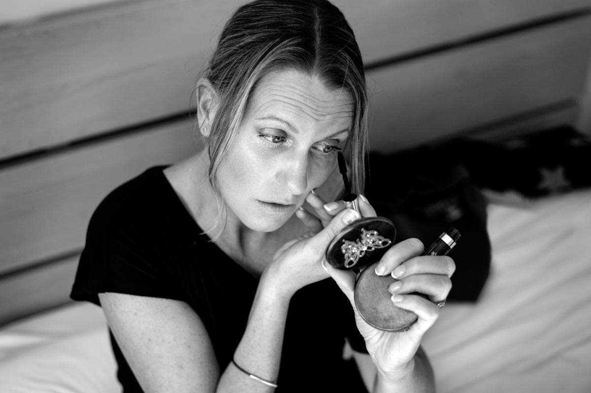 Getting ready wedding photography. Sarah applies her makeup