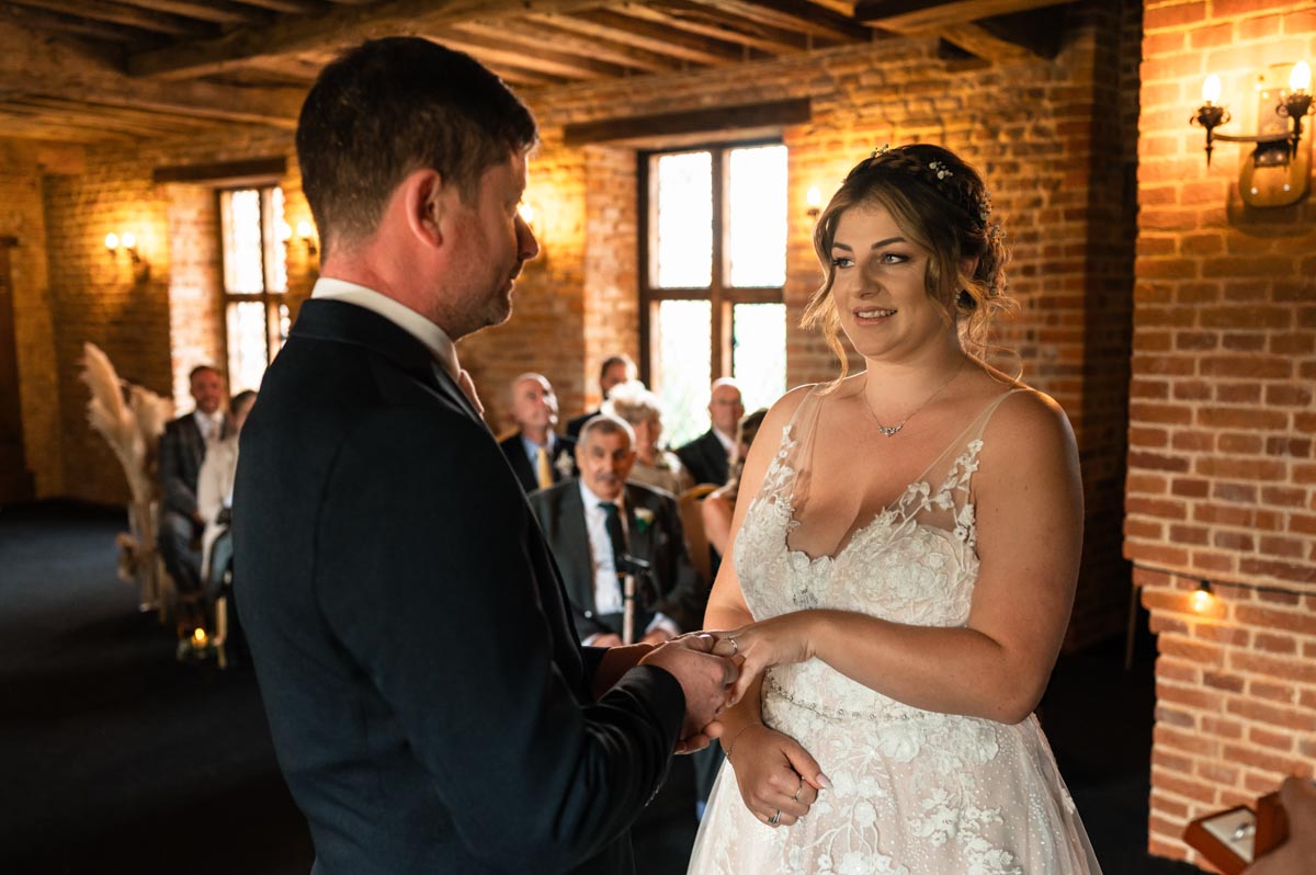 exchange of wedding rings between david and paige during their westenhanger castle wedding