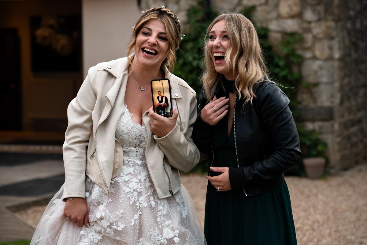 bride and bridemaids laughing at westenhanger castle wedding