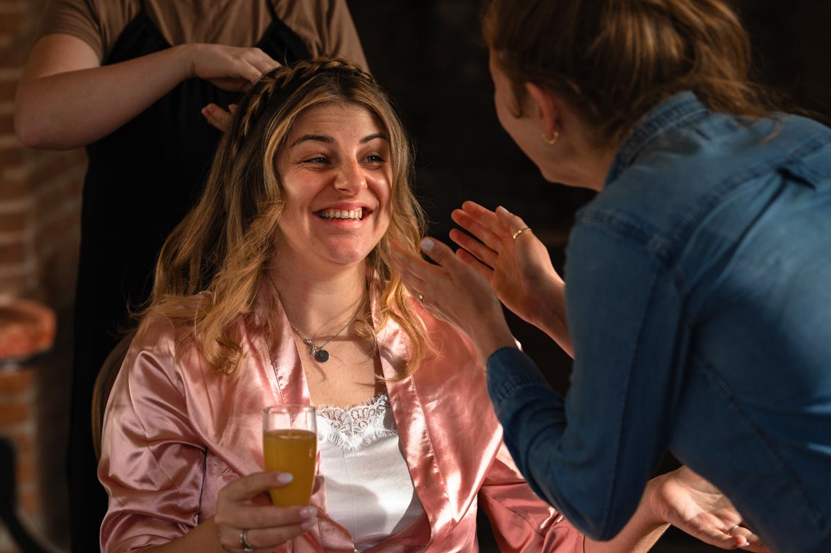 Westenhanger castle wedding. paige shares a laugh with her friend while getting ready