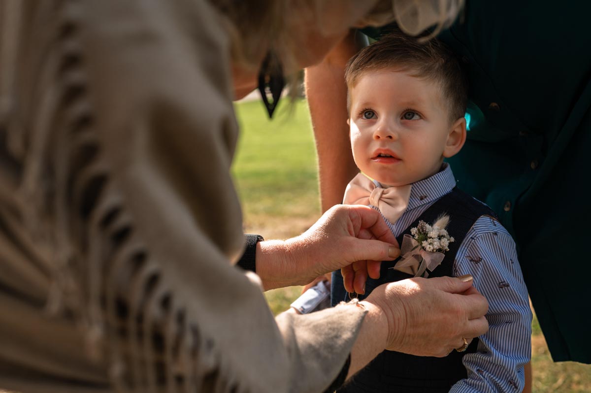 westenhanger castle wedding photography. pageboy has his buttonhole fixed
