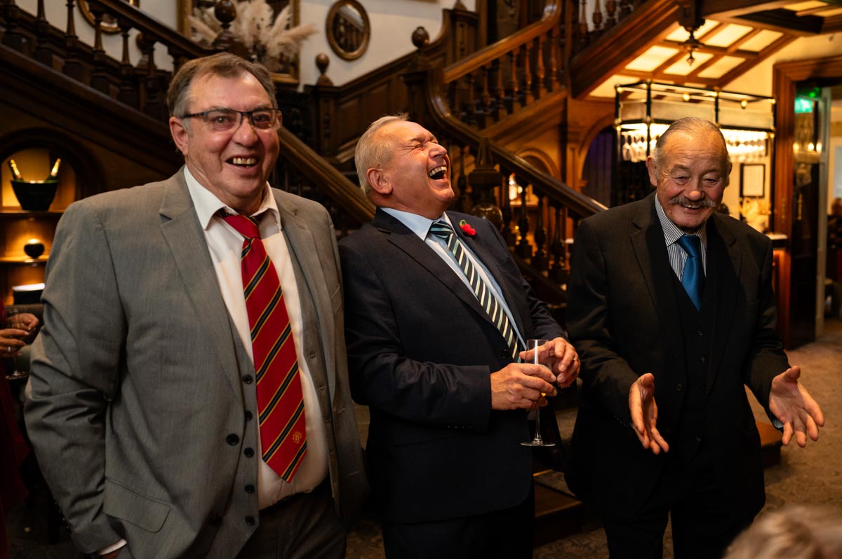 Wedding photography at Chilston park Hotel. Diane and James wedding guests laughing