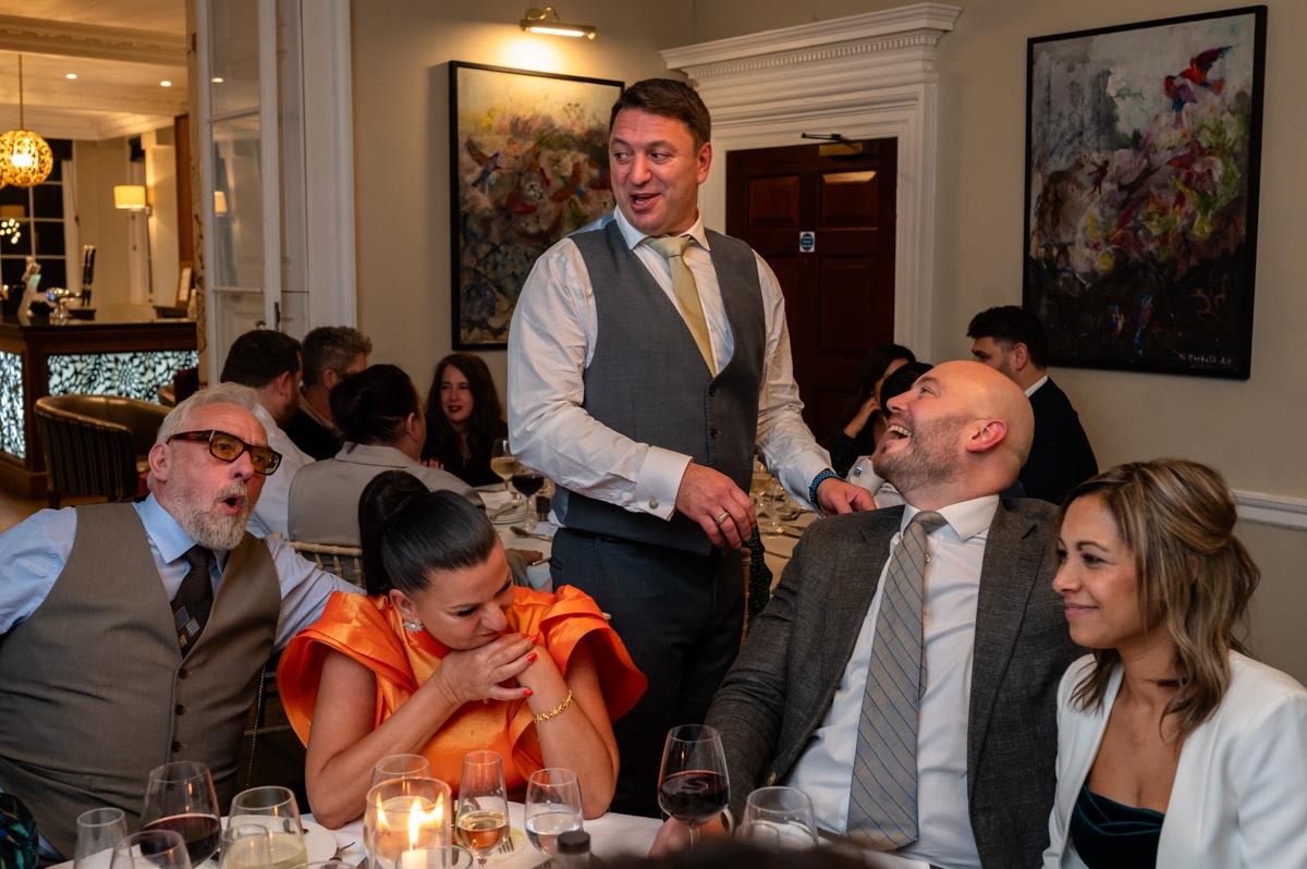 James laughs with wedding guests at Chilston park Hotel