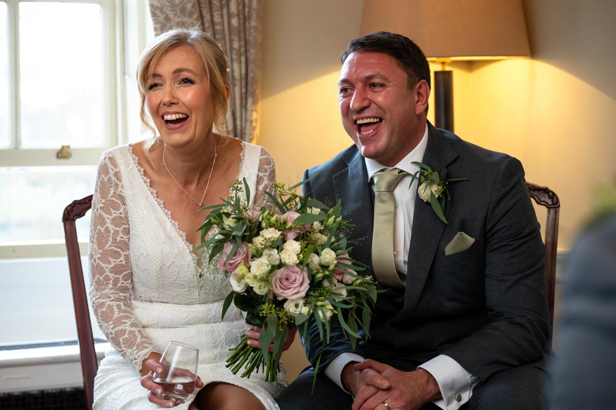 Diane and James laughing after their Chilston Park Hotel wedding ceremony