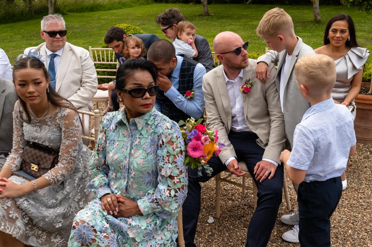 A taste of my 2024 weddings. The Secret Garden in Kent. Wedding guests seated for outddor ceremony.