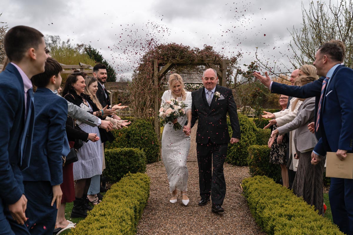 A taste of my 2024 weddings. Jane and Andrew photographed walking down the aisle during confetti throw